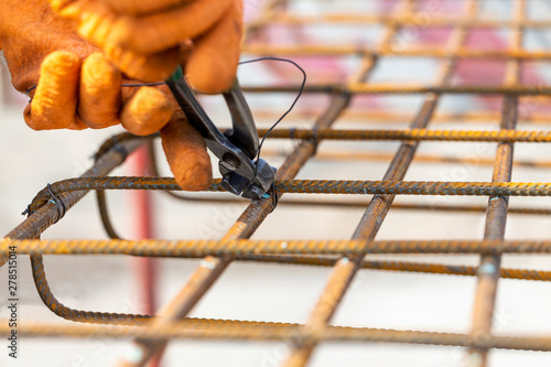 Tying reinforcing steel bars for the construction