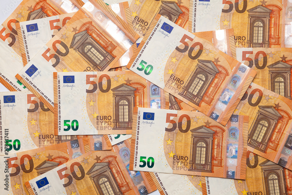 Pile of fifty 50 and hundred 100 euros EU bills background. EU note. Top view. Flat lay. Business concept Pile of fifty 50 and hundred 100 euros EU bills background. EU note. Top view. Flat lay. Business concept
