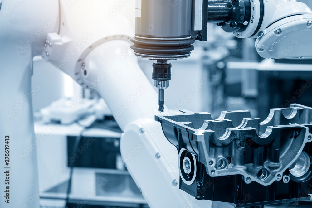 The automotive parts finishing process by milling spindle attach the robotic arm. The aluminium casting parts manufacturing process. The automotive parts finishing process by milling spindle attach the robotic arm. The aluminium casting parts manufacturing process.