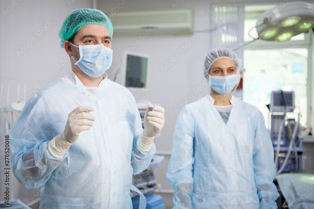 Medical assistant helps a surgeon. Medical assistant helps a surgeon.