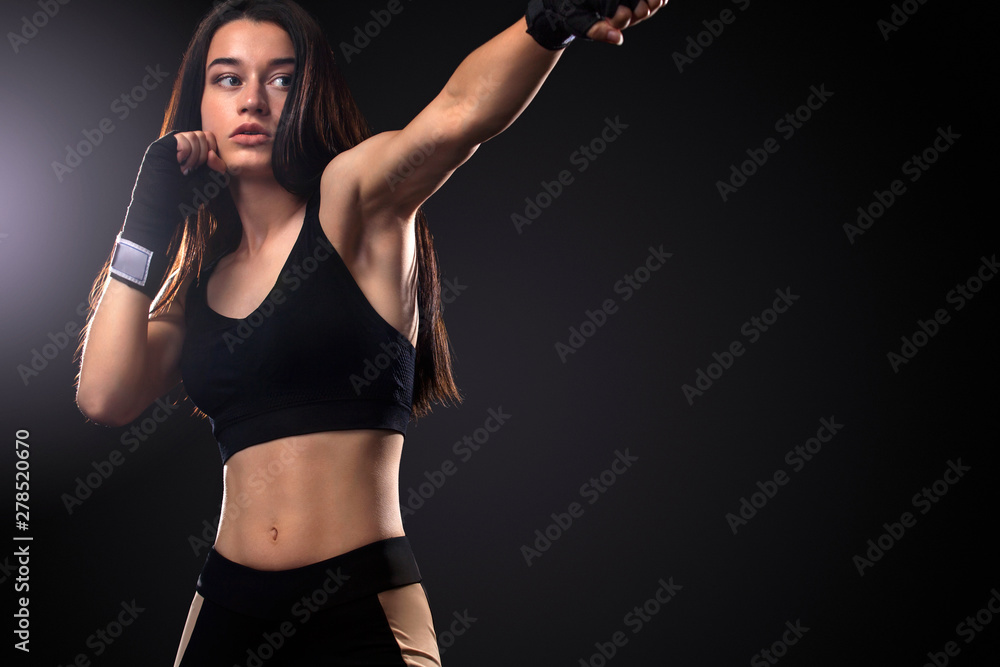 Sportsman, woman boxer fighting in gloves on black background. Boxing and fitness concept. Sportsman, woman boxer fighting in gloves on black background. Boxing and fitness concept.