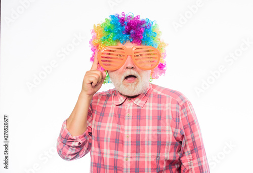 Nice joke. Elderly clown. Man senior bearded cheerful person wear colorful wig and sunglasses. Grandpa always fun. Having fun. Funny lifestyle. Fun and entertainment. Comic grandfather concept