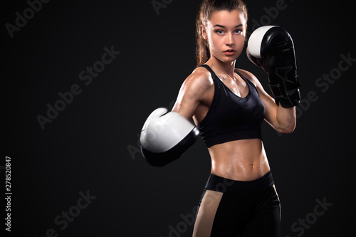 Woman boxer on black background. Boxing and fitness concept.