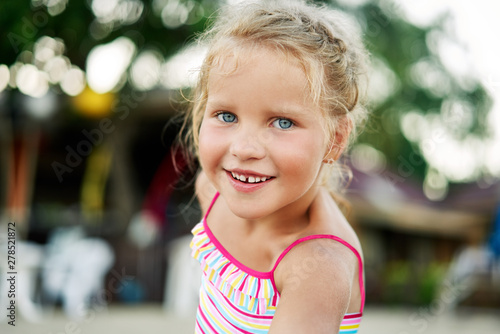 Close up portrait of happy cute little blonde girl