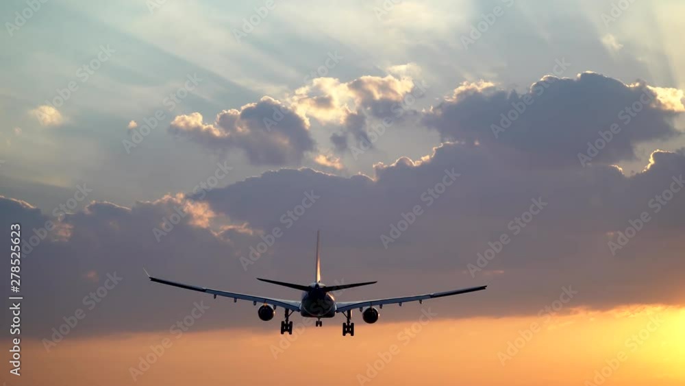 Tracking shot of airplane landing in beautiful morning sky Tracking shot of airplane landing in beautiful morning sky