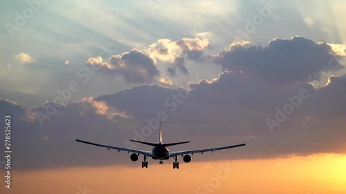 Tracking shot of airplane landing in beautiful morning sky
