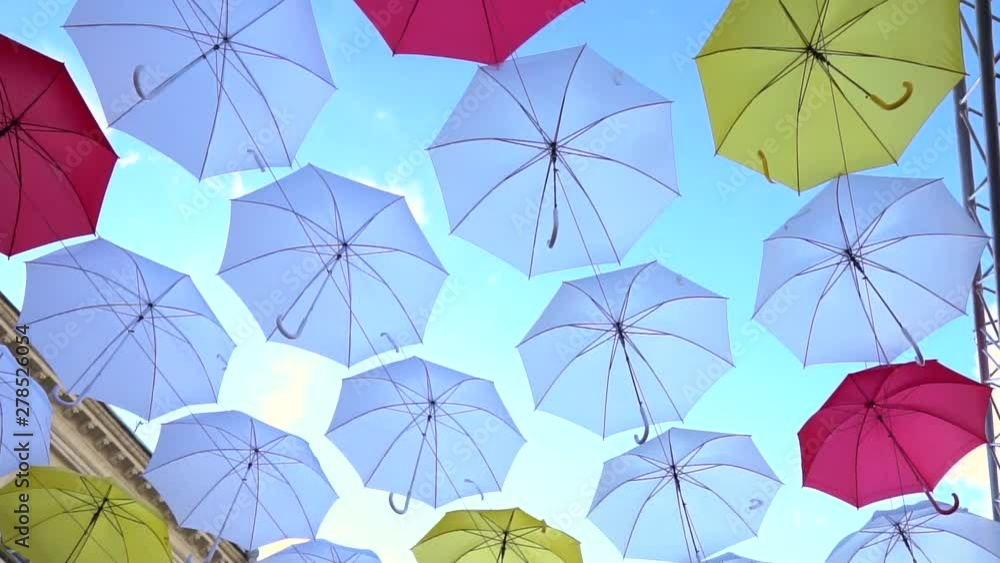 Tilt shot of the colorful umbrellas hanging in the sky. Street Decorated With Colored Umbrellas Tilt shot of the colorful umbrellas hanging in the sky. Street Decorated With Colored Umbrellas