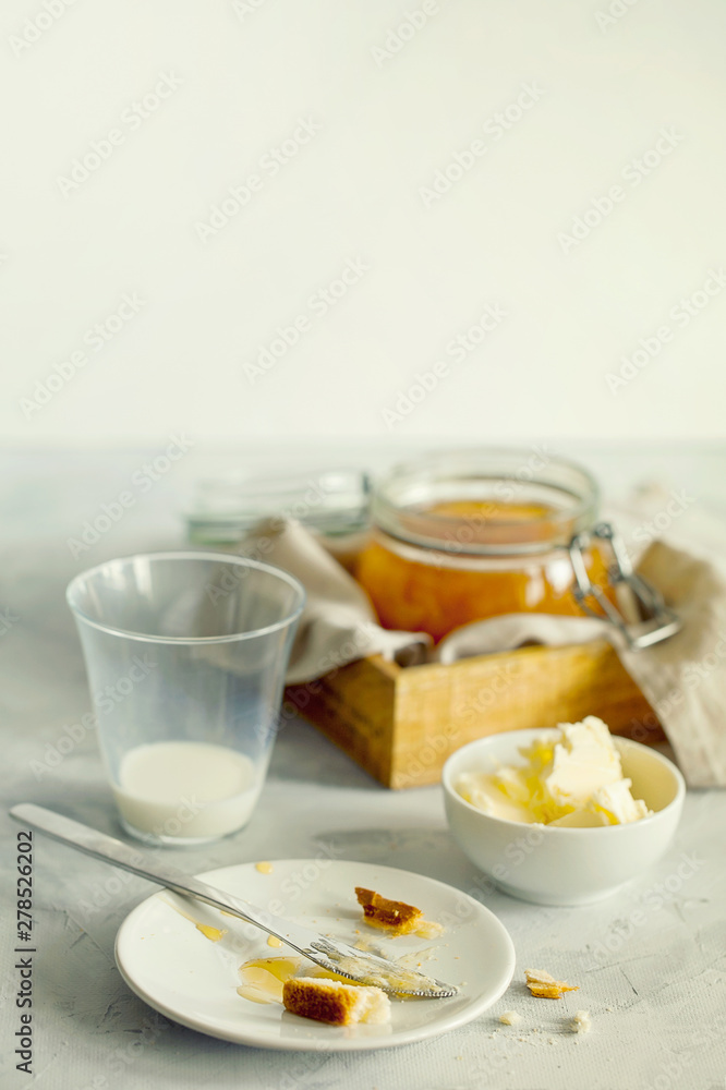 The remains of Breakfast in plates,crumbs on the morning table.Healthy breakfast food concept.A stylish breakfast on a light table close-up with space for text The remains of Breakfast in plates,crumbs on the morning table.Healthy breakfast food concept.A stylish breakfast on a light table close-up with space for text