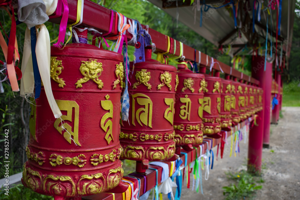 Small stationary metal drums on Buddhist square