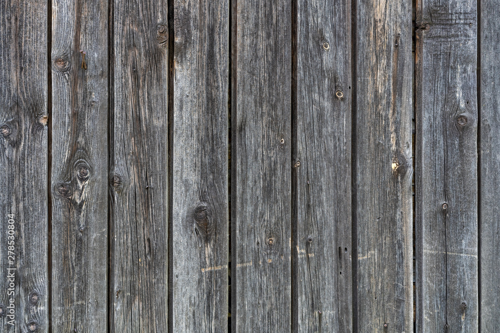 old peeling wooden boards. Background natural wooden boards. Texture of old unpainted wooden planks. Vertical arrangement of shabby wooden boards. old peeling wooden boards. Background natural wooden boards. Texture of old unpainted wooden planks. Vertical arrangement of shabby wooden boards.