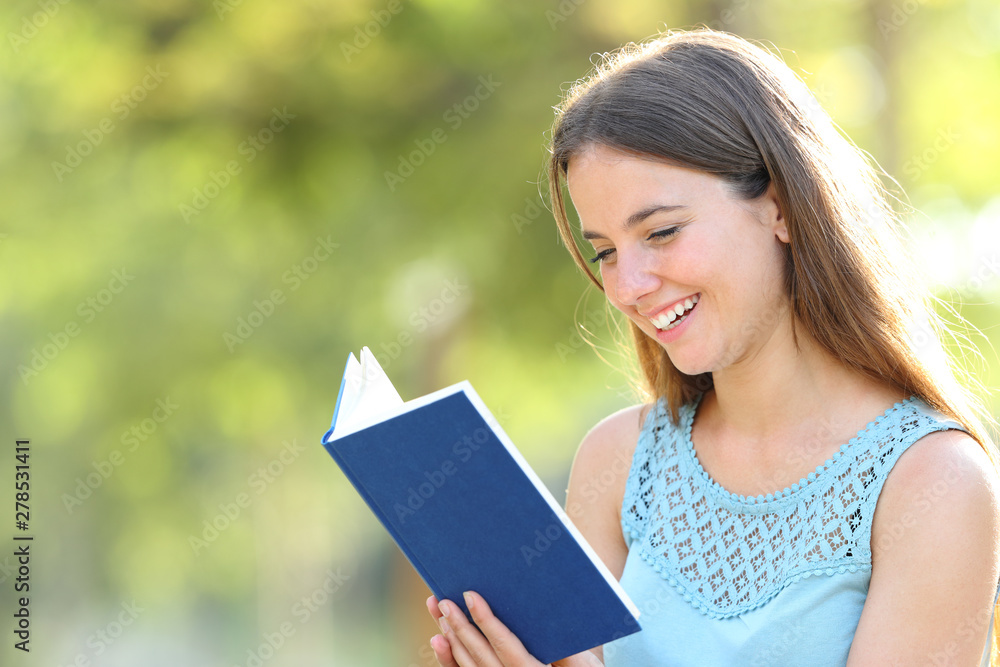 Happy woman reading a book on green background Happy woman reading a book on green background