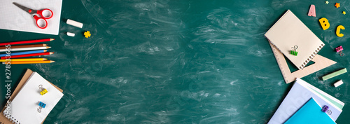 Banner. Still life with school supplies. Blackboard in chalk chalkboard. Green background. Notebooks, notebooks, felt-tip pens, colored pencils. Beginning of the school year.