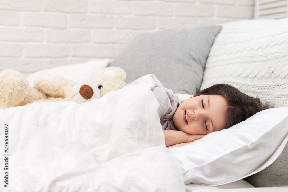 Cute little child girl sleeping with teddy bear in her bed Cute little child girl sleeping with teddy bear in her bed