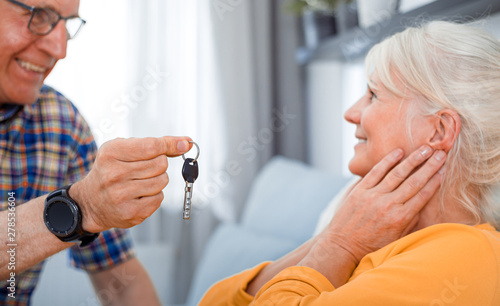 Senior husband giving keys of new house to his wife