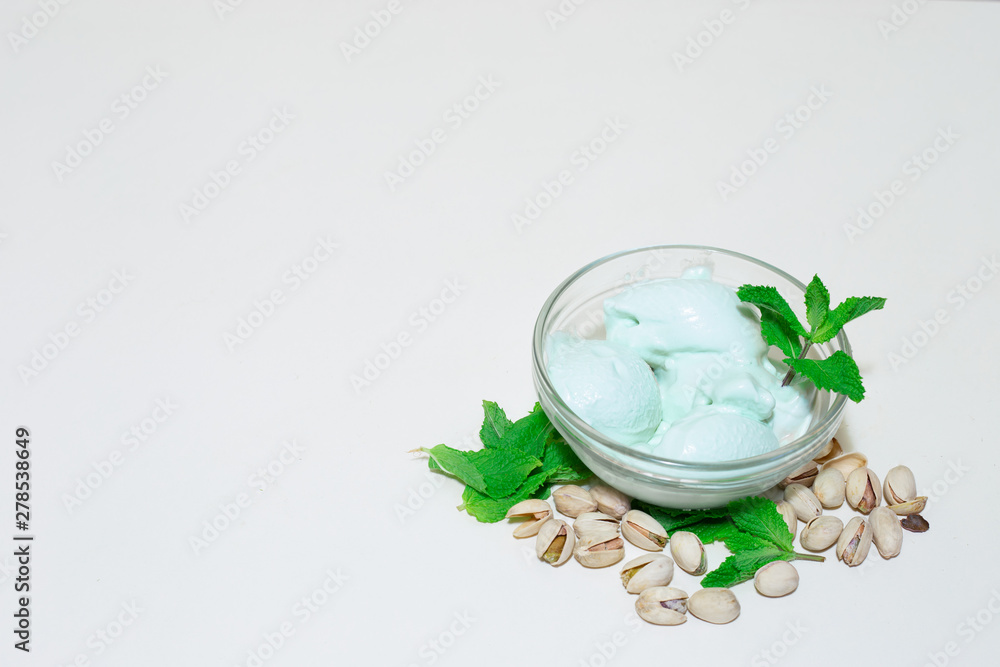 Pistachio and mint green ice cream on whit background with copy space – homemade cold desert with nut flavor – Frozen sweet and healthy refreshment Pistachio and mint green ice cream on whit background with copy space – homemade cold desert with nut flavor – Frozen sweet and healthy refreshment