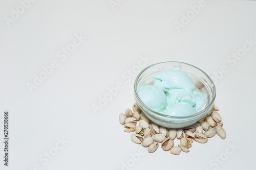 Green ice cream from pistachio with creamy texture on white background with copy space – Sweet and tasty frozen desert with nut flavor made at home