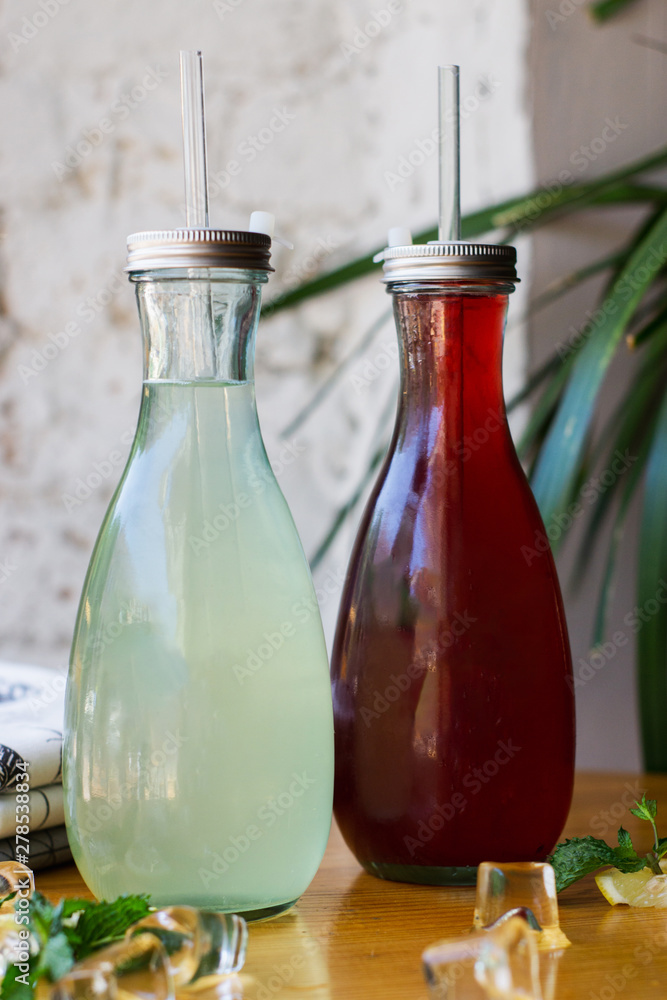Fresh homemade lemonade in a bottle on the table. Rustic Style. Fresh homemade lemonade in a bottle on the table. Rustic Style.