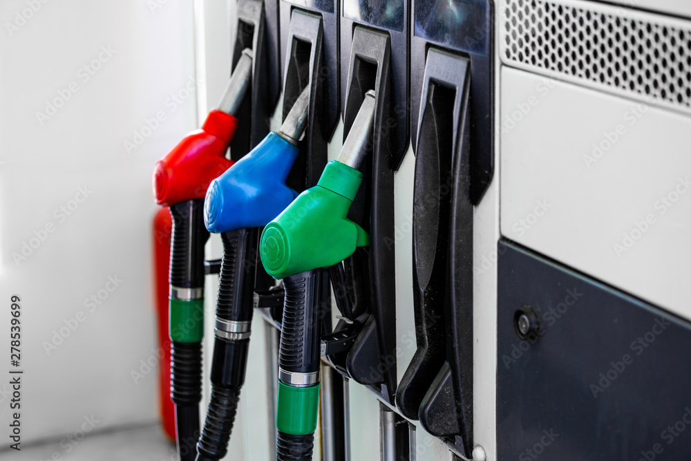 Gas pump nozzles in service station. Colorful Petrol pump filling nozzles, Gas station in a service. Gas pump nozzles in service station. Colorful Petrol pump filling nozzles, Gas station in a service.