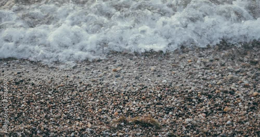 Waves hitting pebble beach at sea closeup 4k Waves hitting pebble beach at sea closeup 4k
