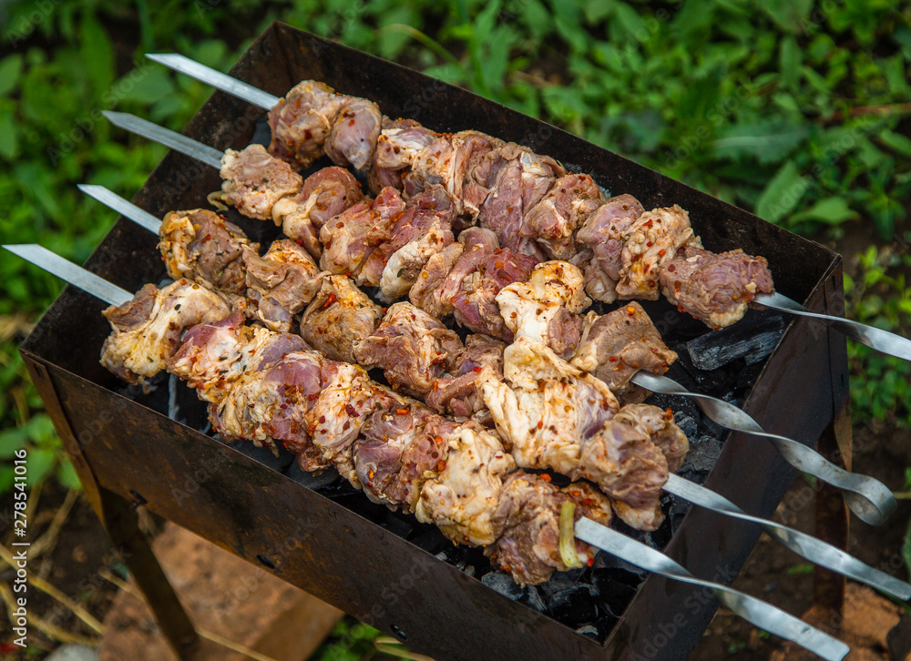 cook shashlik on the grill with coal in the street cook shashlik on the grill with coal in the street