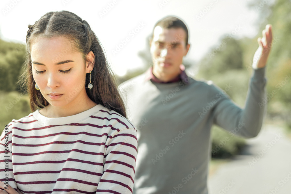 Fototapeta premium Angry man actively gesturing while arguing with girlfriend
