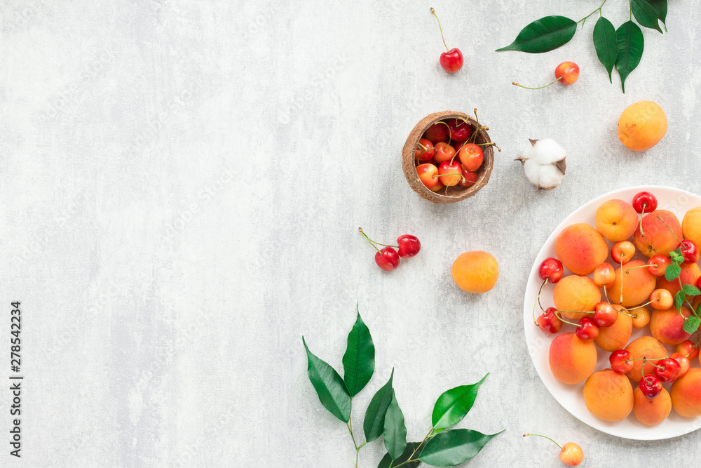 Summer fruits on grey background, flat lay, top view Summer fruits on grey background, flat lay, top view