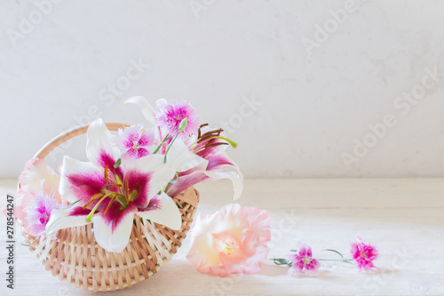 summer flowers in basket on white background