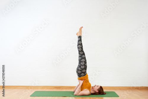 Female doing yoga asana for healthy back photo