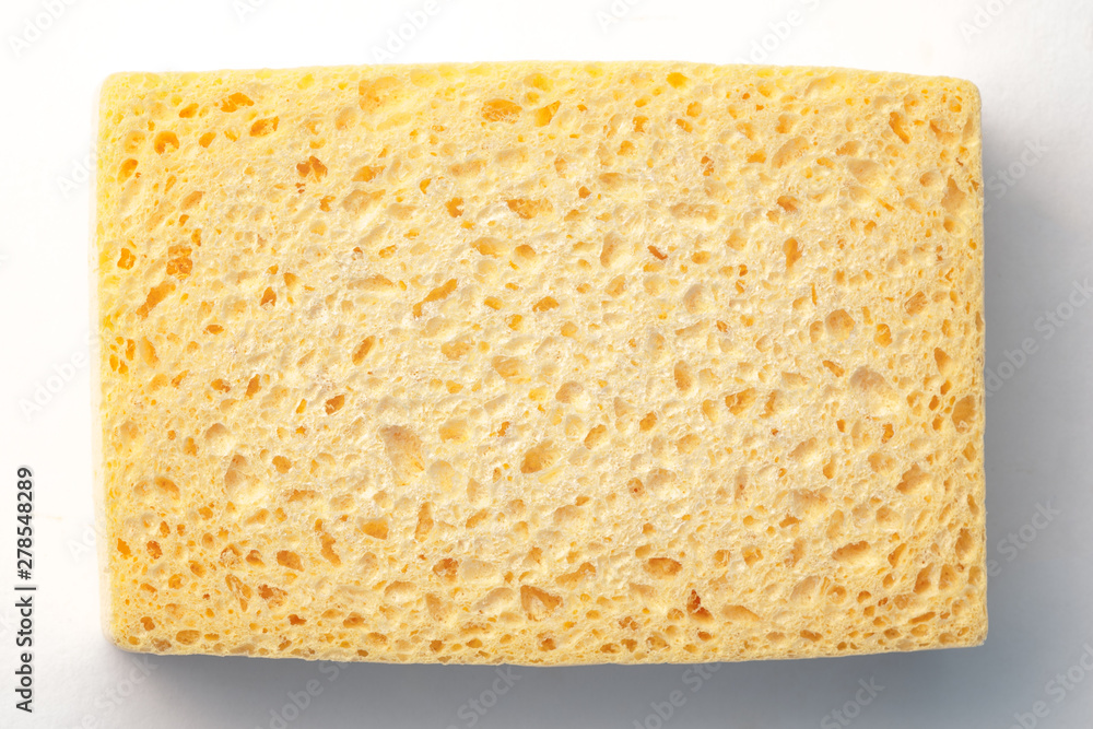 yellow pierced sponge on white and grey background yellow pierced sponge on white and grey background