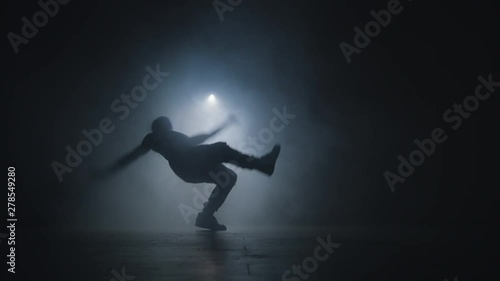 Young stuntman performing the trick in the air. Making complex movements. Air spinning.