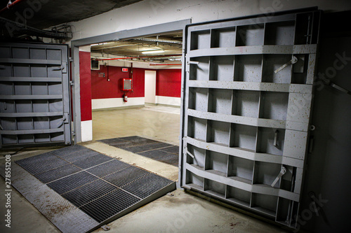 Vászonkép Details with the heavy metal doors of a nuclear explosion shelter (fallout shelter), four stories below ground in a deep underground parking place