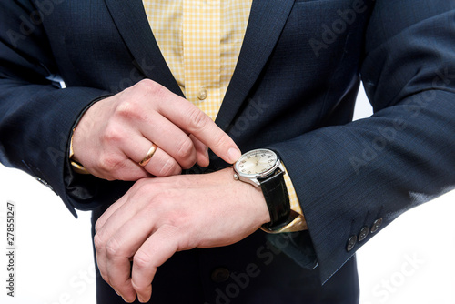 Businessman looking at clock on his hand is isolated on white background