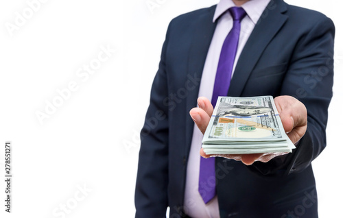 Man in business suit holds one hundred dollar denominations