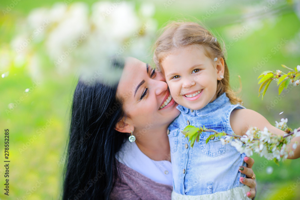 motherhood. mother with a small daughter in a beautiful park at sunset. people concept. motherhood. mother with a small daughter in a beautiful park at sunset. people concept.