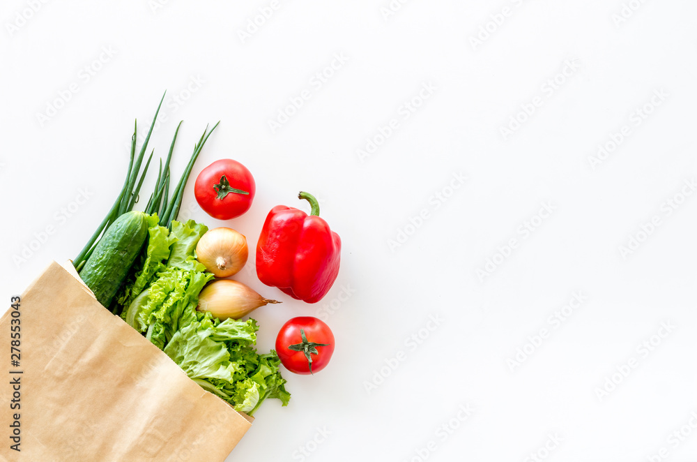 Healthy food with fresh vegetables in paper bag on white background top view space for text Healthy food with fresh vegetables in paper bag on white background top view space for text