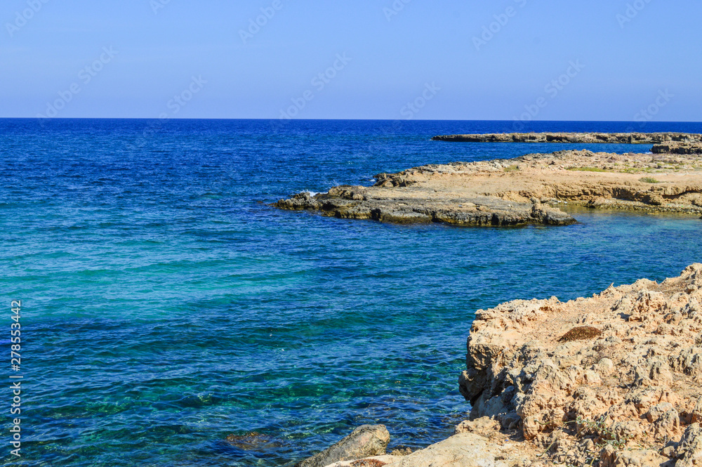 Protaras, the island of Cyprus. Mediterranean coastline. A sunny day, blue sky, coral coast. Background. Copy space.