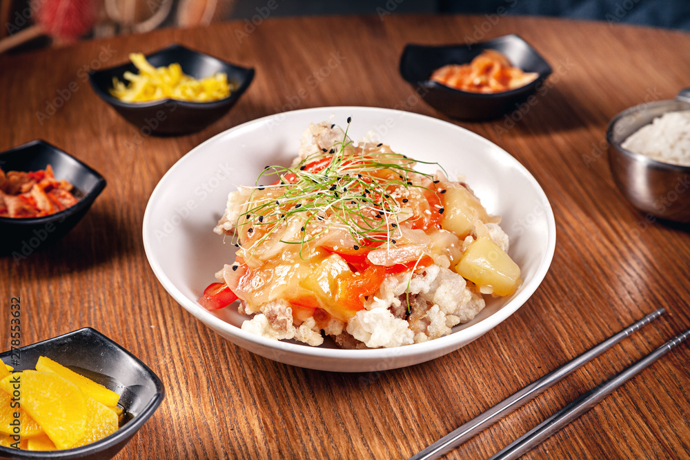 Close up korean traditional food with kimchi on wooden background. Korean rice with onions, red sauce and sesame, chicken meat. Traditional asian cuisine. Lunch. Healthy food Close up korean traditional food with kimchi on wooden background. Korean rice with onions, red sauce and sesame, chicken meat. Traditional asian cuisine. Lunch. Healthy food