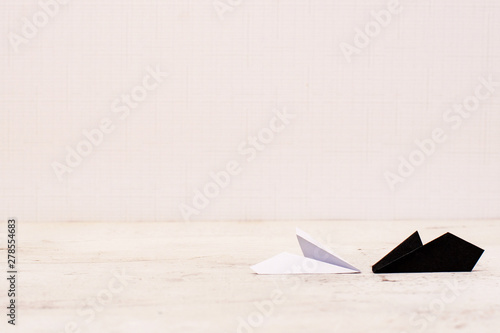 Black and white paper plane on a light background.