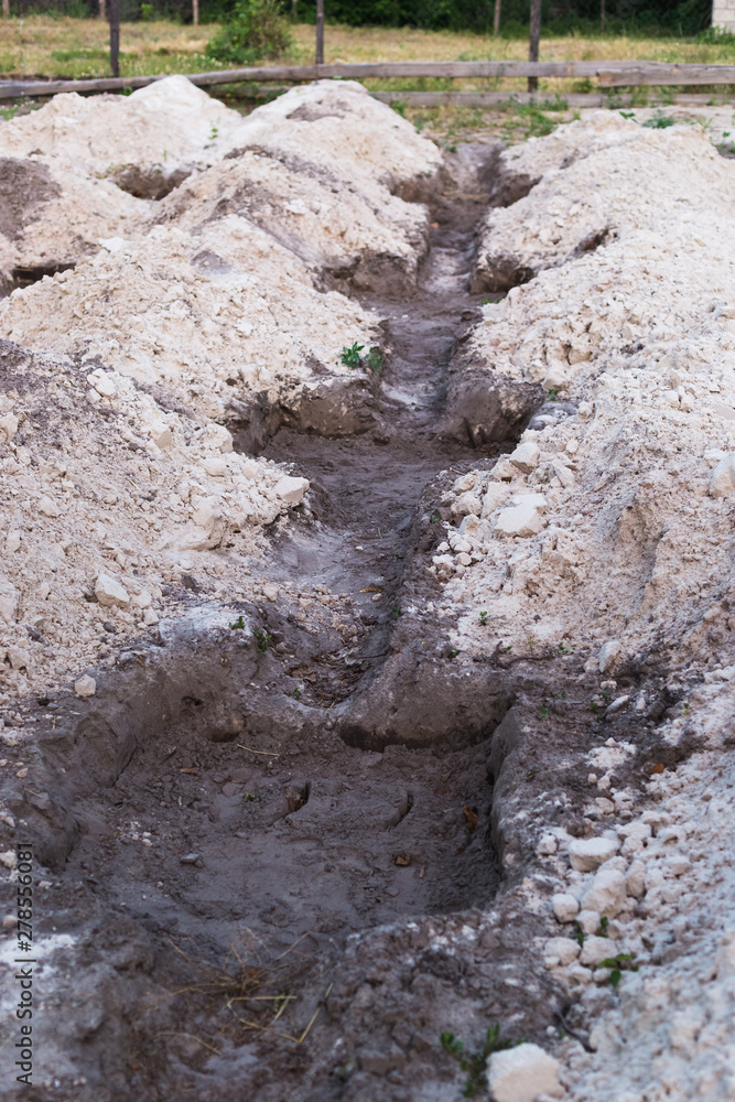 The process of preparing the land for planting grapes. Digging holes The process of preparing the land for planting grapes. Digging holes