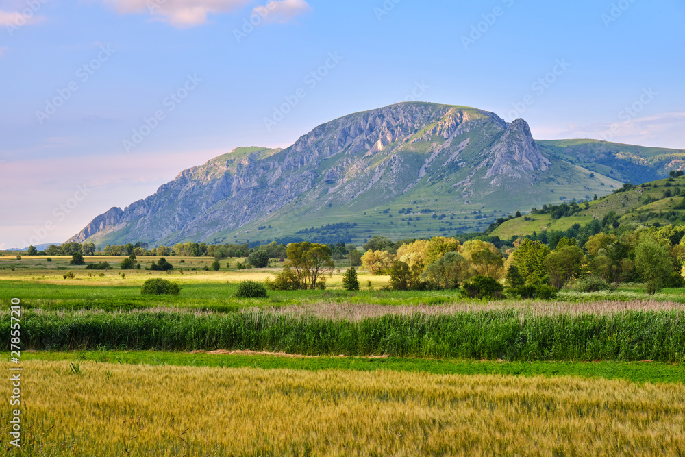 Coltii Trascaului (left) and Piatra Secuiului (right), part of Trascau mountains (Carpathians) - wide view in the warm evening sunlight. Coltii Trascaului (left) and Piatra Secuiului (right), part of Trascau mountains (Carpathians) - wide view in the warm evening sunlight.