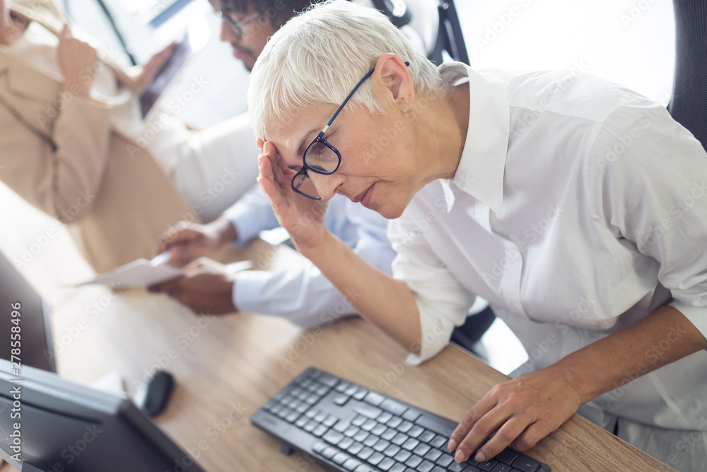 Business, people, fail concept - business people with laptop computer and papers working in office Business, people, fail concept - business people with laptop computer and papers working in office