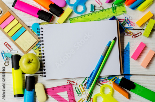 School and office supplies on a wooden photo
