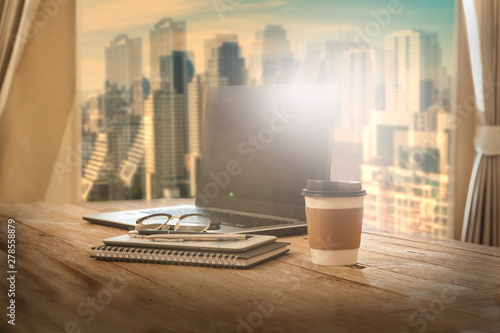 Office table with notebook and cup of coffee