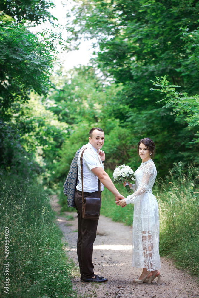 couple walking down the road, back view couple walking down the road, back view