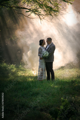 Beautiful couple on the background of smoke © Mallivan