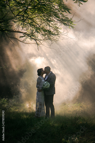 Beautiful Couple kisses on the background of smoke © Mallivan