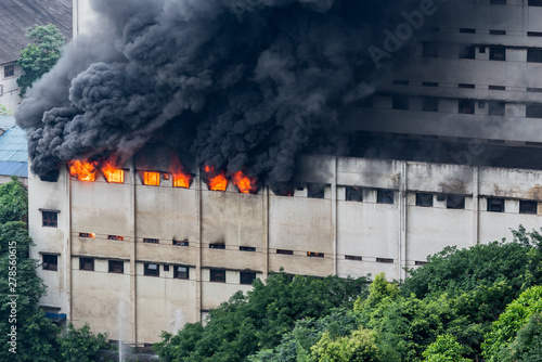 A fire broke out in the warehouse and the fire brigade was putting out the fire. photo