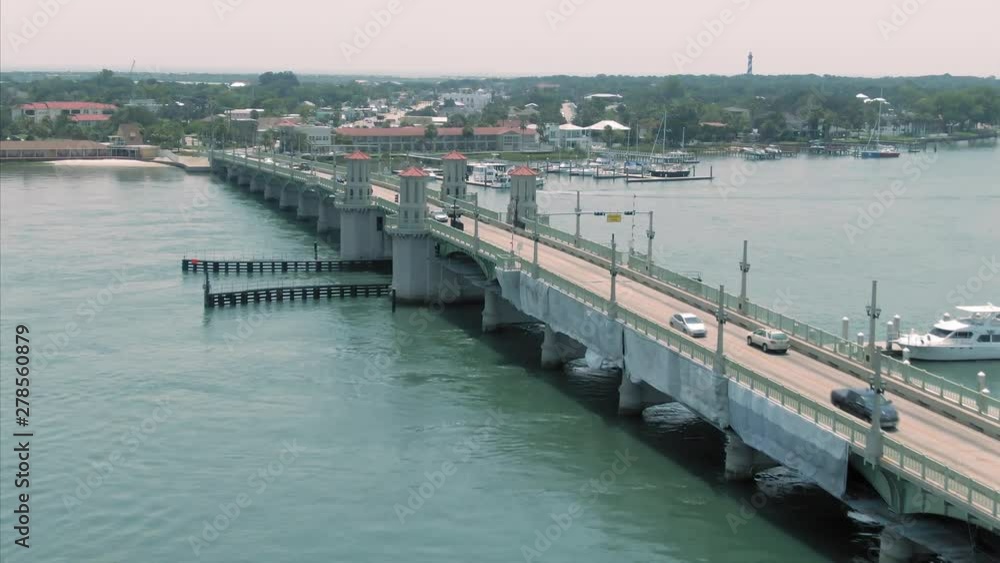 Aerial: Traffic driving over the Bridge of Lions on the Matanzas River. In the background is the city of St Augustine, Florida, USA Aerial: Traffic driving over the Bridge of Lions on the Matanzas River. In the background is the city of St Augustine, Florida, USA