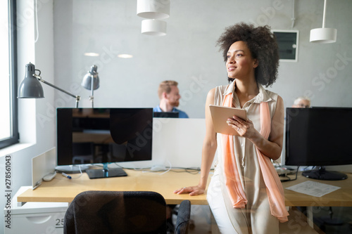 Fotografi Young african american woman working with tablet in office