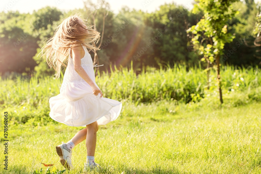 Girl runs through the grass in a white dress Girl runs through the grass in a white dress